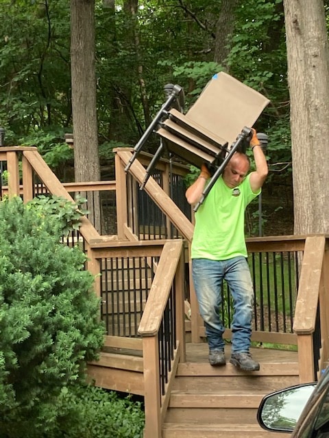 one worker lifting chairs